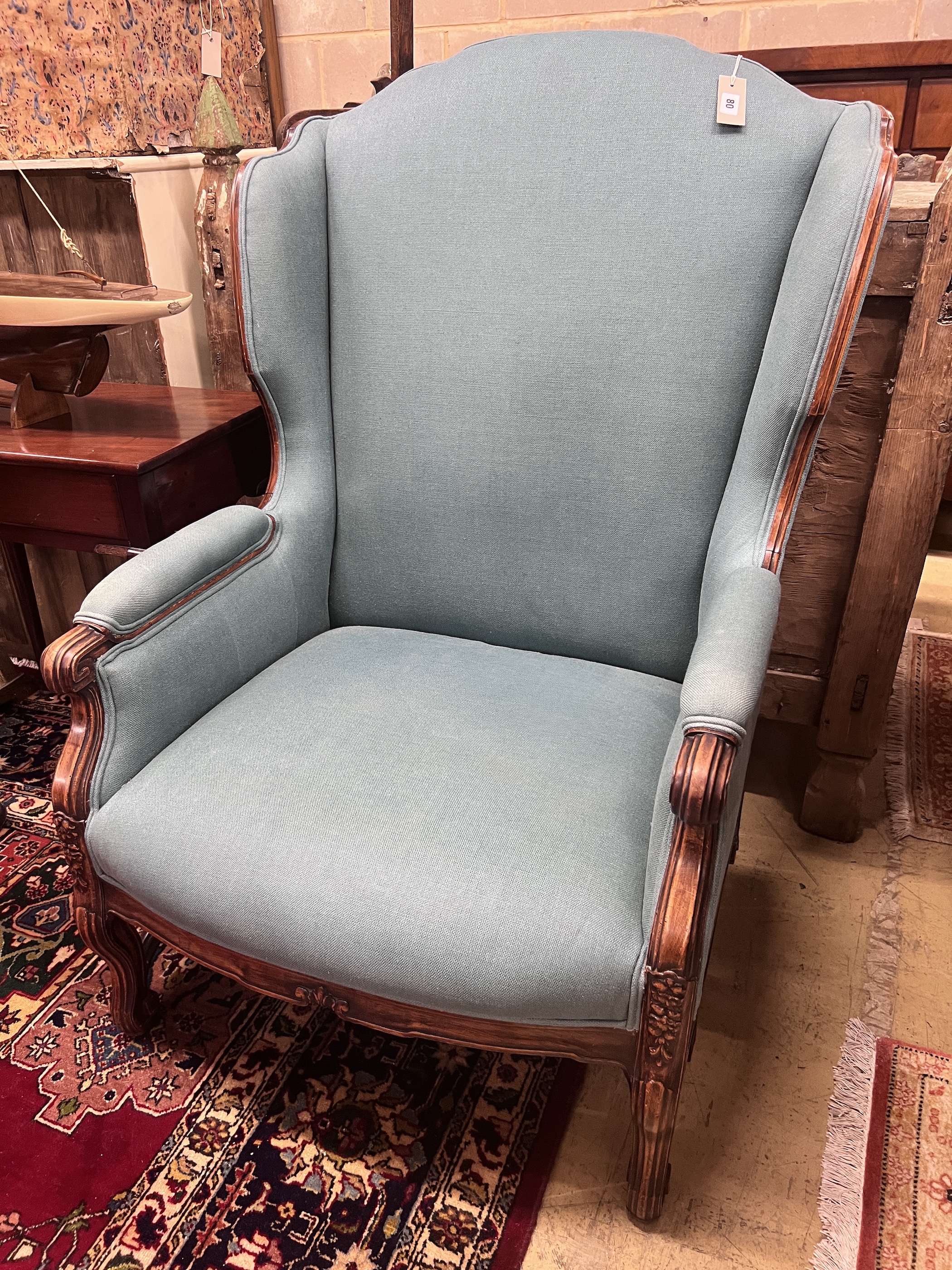 A large Louis XVI style upholstered wing armchair, width 80cm, depth 82cm, height 116cm